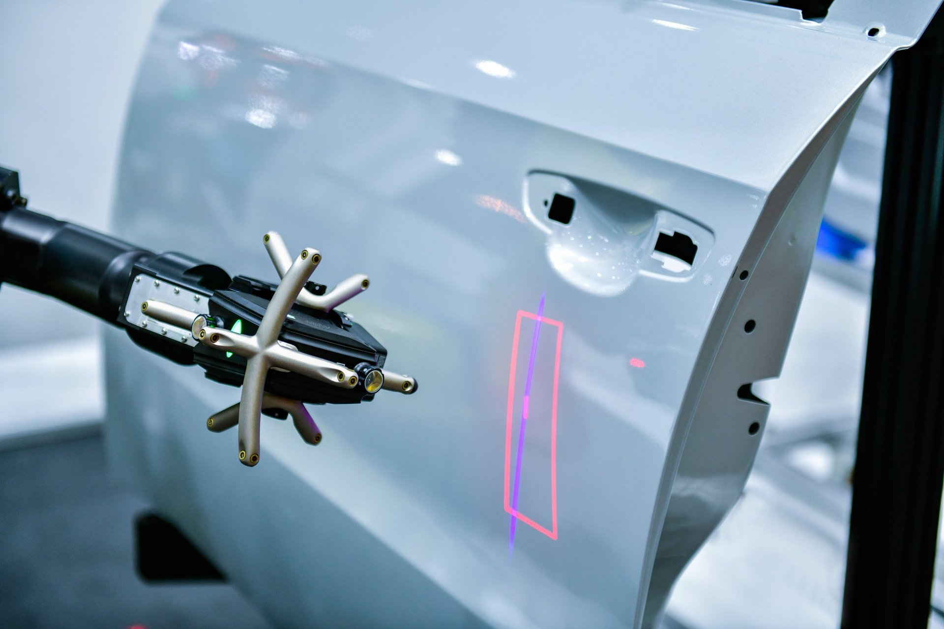 3D scanner on robotic arm measuring automotive parts precision in industrial plant